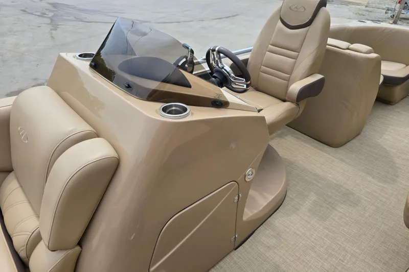 Slide: The Image of 2017 Harris Solstice 240 boat interior with beige seating and steering console. - 19