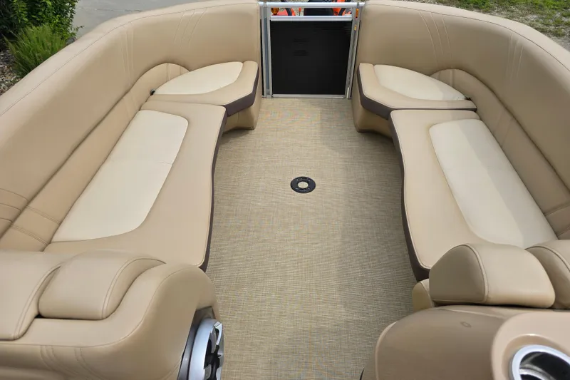 Slide: The Image of 2017 Harris Solstice 240 boat interior with beige seating and carpeted floor. - 20