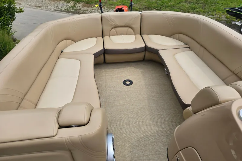 Slide: The Image of 2017 Harris Solstice 240 boat interior with beige seating and spacious layout. - 21