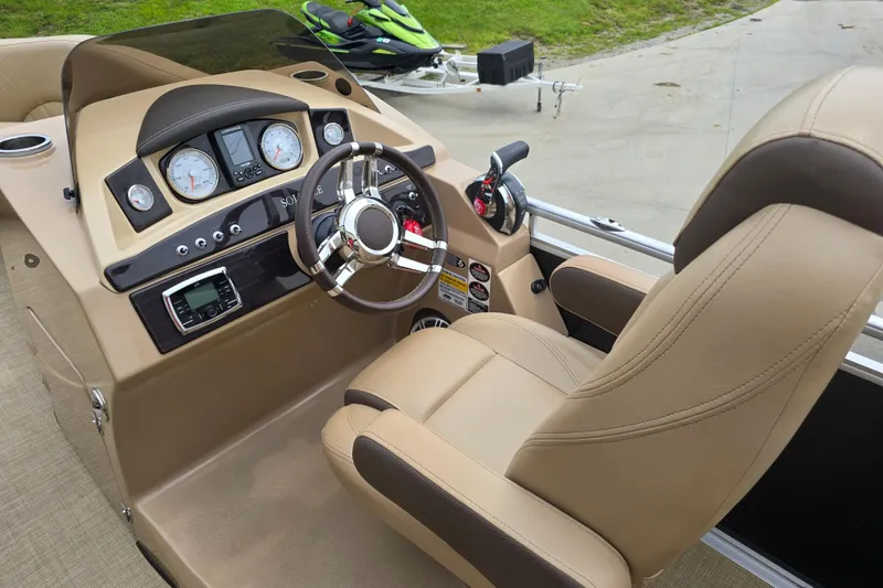 Slide: The Image of 2017 Harris Solstice 240 boat interior with steering wheel and dashboard controls. - 29
