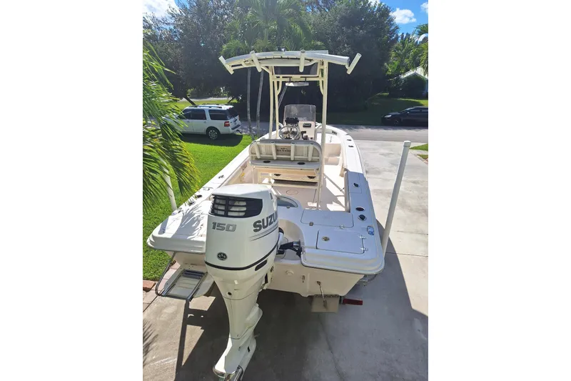 Slide: The Image of 2018 Sea Chaser 21 LX boat with Suzuki 150 outboard motor in driveway. - 1