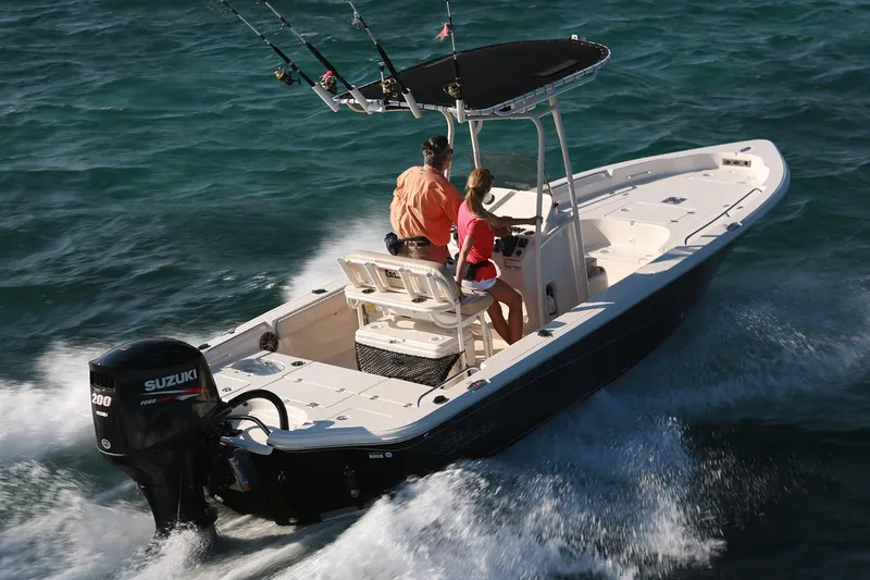 Slide: The Image of 2018 Sea Chaser 21 LX boat with LED light bar on deck, surrounded by trees and house. - 11