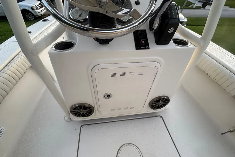 Slide: The Image of 2018 Sea Chaser 21 LX boat console with steering wheel and controls. - 12