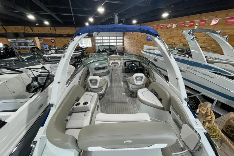 Slide: The Image of 2026 Crownline 260 SS boat interior in showroom, featuring sleek seating and modern design. - 16