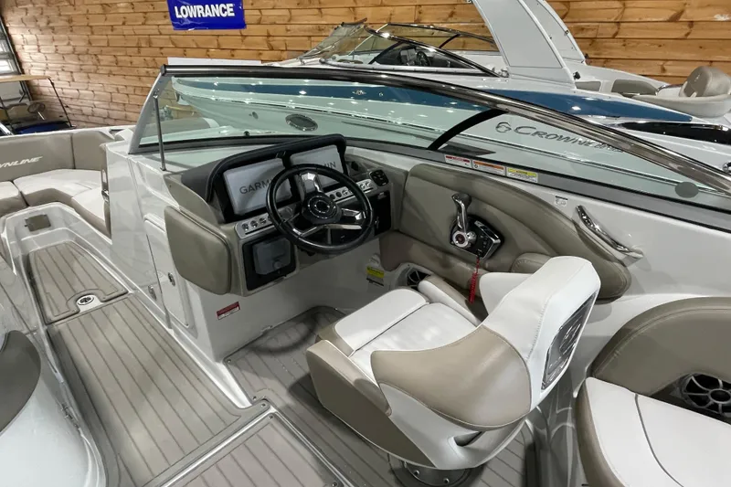 Slide: The Image of 2026 Crownline 260 SS boat interior with steering wheel and seating, featuring modern design. - 18