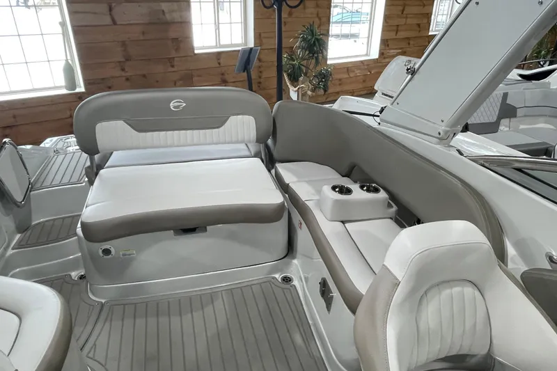 Slide: The Image of 2026 Crownline 260 SS boat interior with plush seating and cup holders. - 21