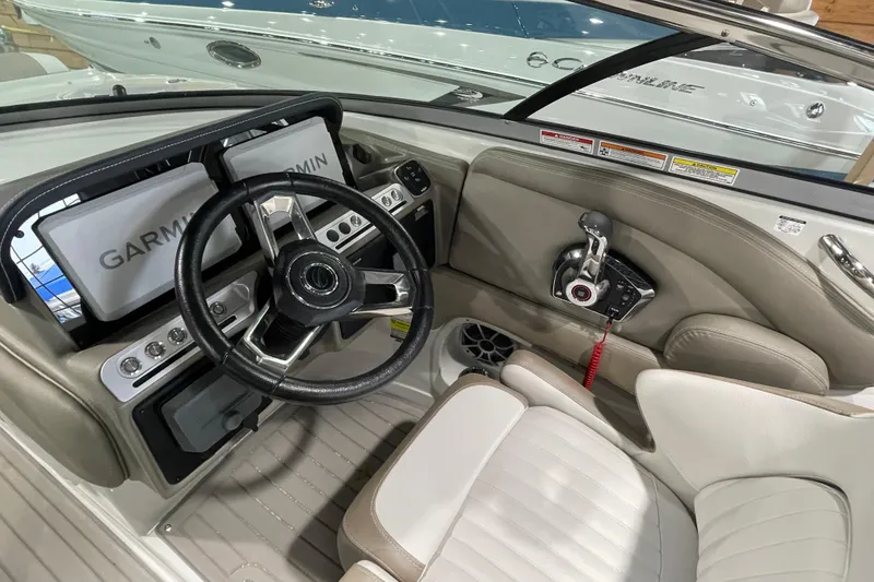 Slide: The Image of Interior of 2026 Crownline 260 SS boat with Garmin navigation system and steering wheel. - 24