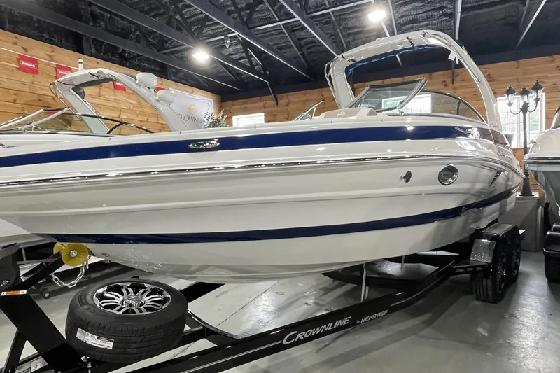 The Image of 2026 Crownline 260 SS boat displayed indoors on a trailer. - 7