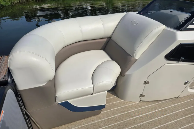 Slide: The Image of Luxurious seating on a 2019 Manitou 21 Oasis RF pontoon boat, featuring elegant upholstery. - 11