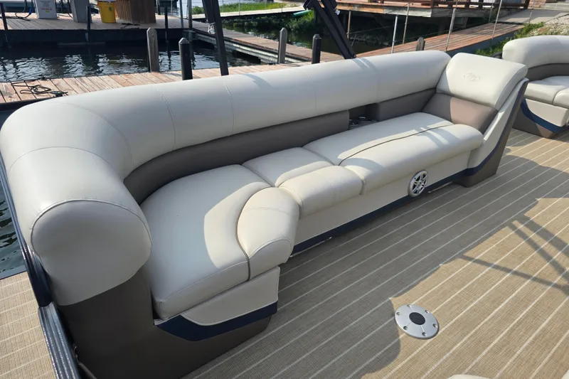 Slide: The Image of Luxurious seating on 2019 Manitou 21 Oasis RF pontoon boat, docked by the water. - 15