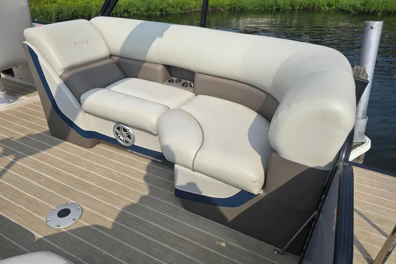 Slide: The Image of 2019 Manitou 21 Oasis RF boat with luxurious seating and speaker on deck. - 16