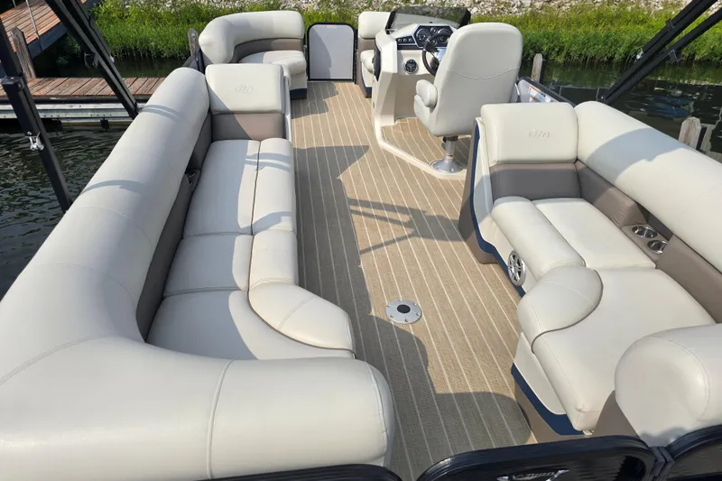 Slide: The Image of 2019 Manitou 21 Oasis RF pontoon boat with spacious seating and modern helm. - 17