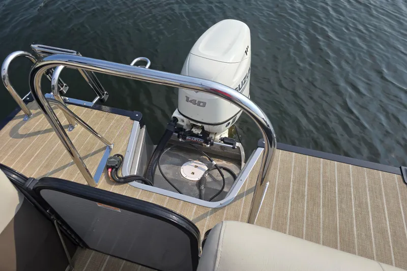 Slide: The Image of 2019 Manitou 21 Oasis RF boat with Suzuki 140 outboard motor on water. - 18