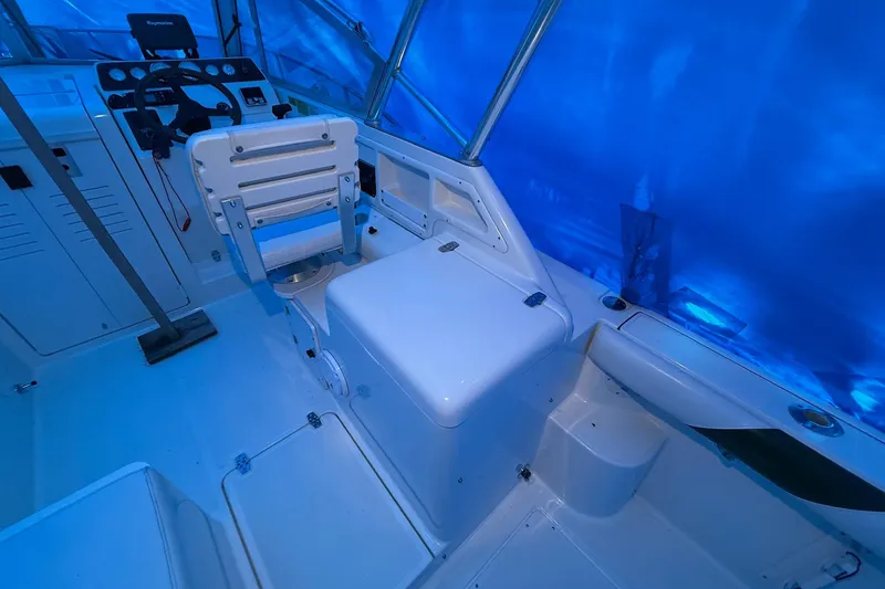 Slide: The Image of 1998 Pursuit 2860 Denali boat interior with helm and seating area. - 14