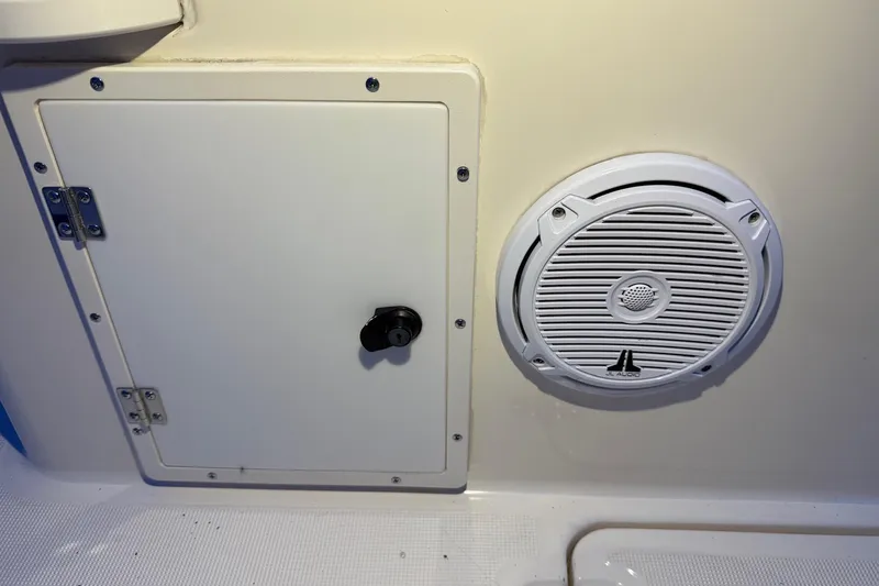 Slide: The Image of 1998 Pursuit 2860 Denali boat interior with speaker and storage compartment. - 17