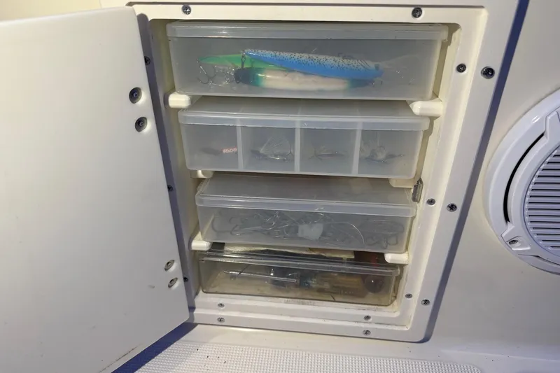 Slide: The Image of Fishing tackle storage on 1998 Pursuit 2860 Denali boat, featuring organized compartments. - 18