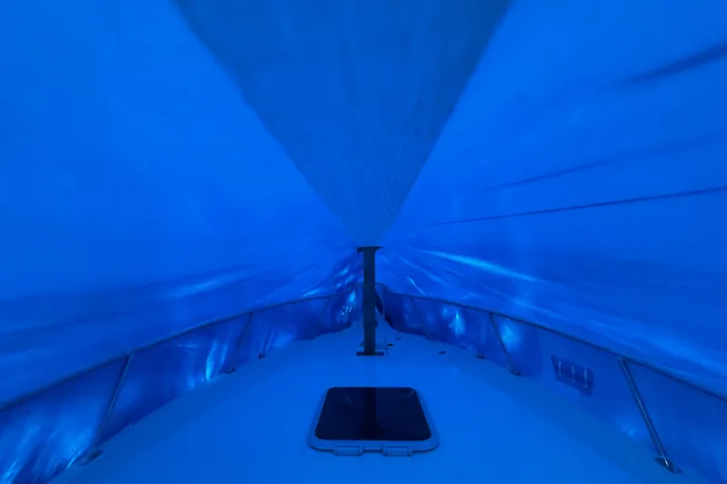 Slide: The Image of Interior view of 1998 Pursuit 2860 Denali boat under blue tarp cover. - 20