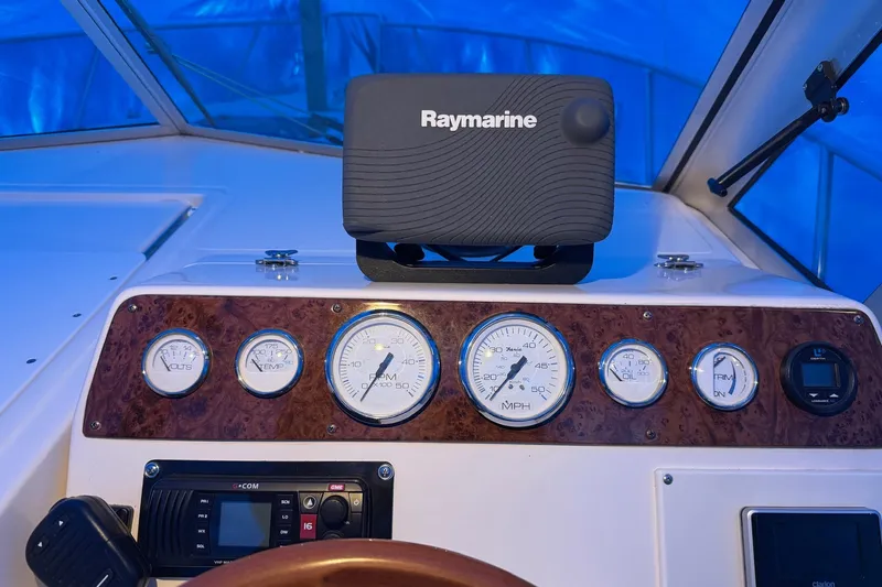 Slide: The Image of Dashboard of a 1998 Pursuit 2860 Denali boat with Raymarine equipment and gauges. - 23