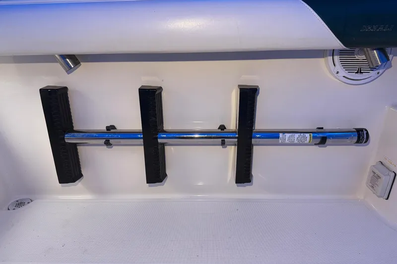 Slide: The Image of 1998 Pursuit 2860 Denali boat interior with mounted rod holder and speaker. - 28