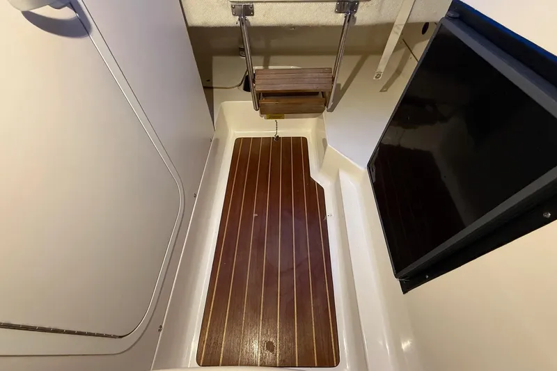 Slide: The Image of 1998 Pursuit 2860 Denali cabin interior with wooden flooring and compact design. - 37
