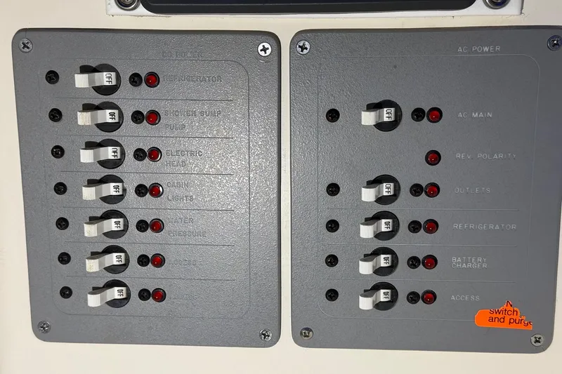 Slide: The Image of Electrical panel with switches and indicators on a 1998 Pursuit 2860 Denali boat. - 41