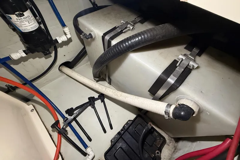 Slide: The Image of Engine compartment of a 1998 Pursuit 2860 Denali boat, showing hoses and fittings. - 50