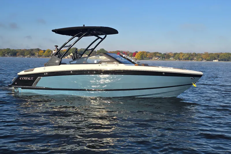 Slide: The Image of 2022 Cobalt R4 Surf boat on a calm lake with scenic background. - 13