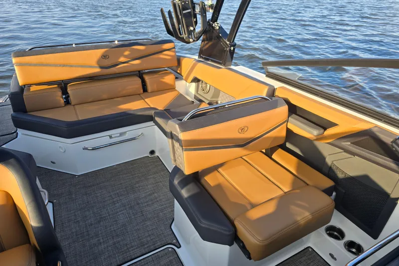 Slide: The Image of 2022 Cobalt R4 Surf boat interior with tan leather seating and water backdrop. - 14