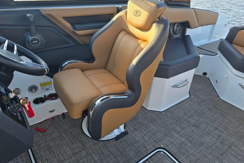 Slide: The Image of 2022 Cobalt R4 Surf boat interior with tan leather captain's chair and modern controls. - 15
