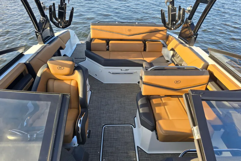 Slide: The Image of 2022 Cobalt R4 Surf boat interior with tan seating, on water. - 16