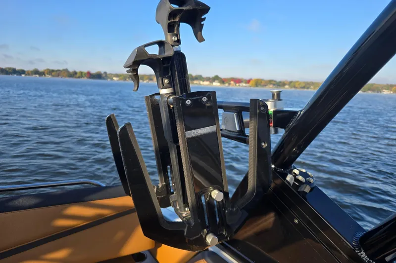 Slide: The Image of Cobalt R4 Surf 2022 boat with wakeboard rack on a sunny lake. - 20