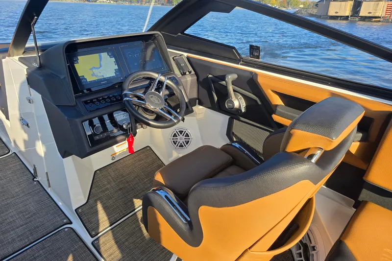 Slide: The Image of 2022 Cobalt R4 Surf boat cockpit with modern controls and navigation system. - 22