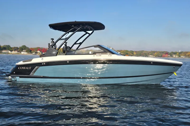 Slide: The Image of 2022 Cobalt R4 Surf boat on calm water, showcasing sleek design and modern features. - 28