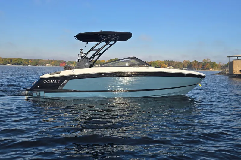 Slide: The Image of 2022 Cobalt R4 Surf boat on a calm lake under clear blue sky. - 33