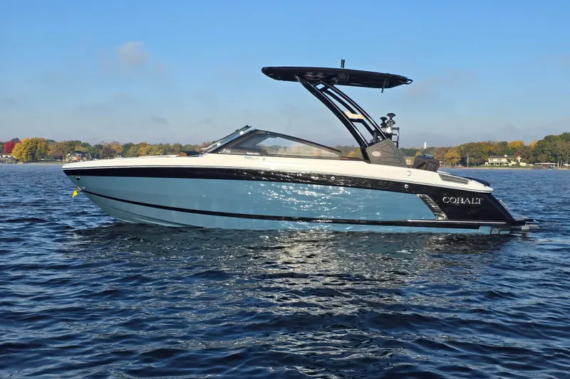 Slide: The Image of 2022 Cobalt R4 Surf boat on a calm lake with scenic background. - 5