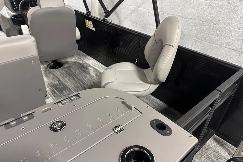 Slide: The Image of Interior of 2025 Qwest 18 XRE Cruise boat with modern seating and dashboard. - 2