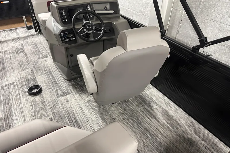 Slide: The Image of Interior of 2025 Qwest 18 XRE Cruise boat with modern steering console and seating. - 3