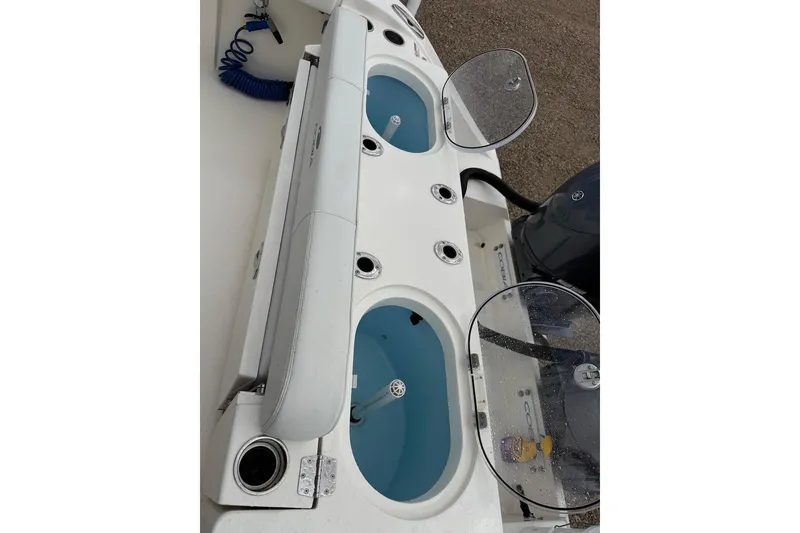 Slide: The Image of 2023 Cobia 301 Center Console boat with livewell and rod holders. - 6