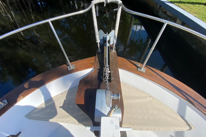 Slide: The Image of Bow view of 1974 CHB 34 boat with anchor and railing in a canal setting. - 17