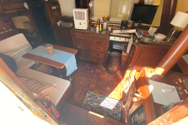 Slide: The Image of Interior of a 1974 CHB 34 boat with cozy seating and wooden cabinetry. - 24