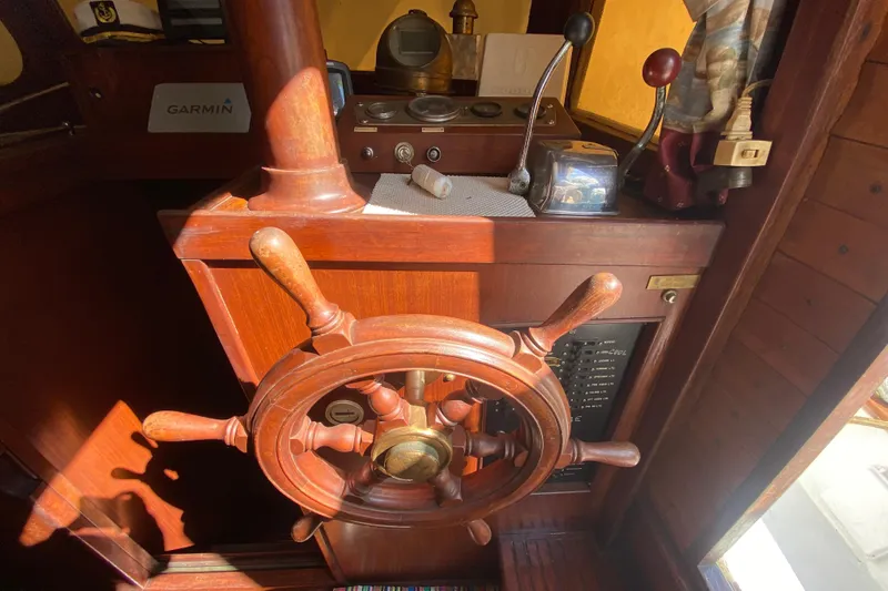 Slide: The Image of Wooden helm of a 1974 CHB 34 boat with navigation equipment. - 26