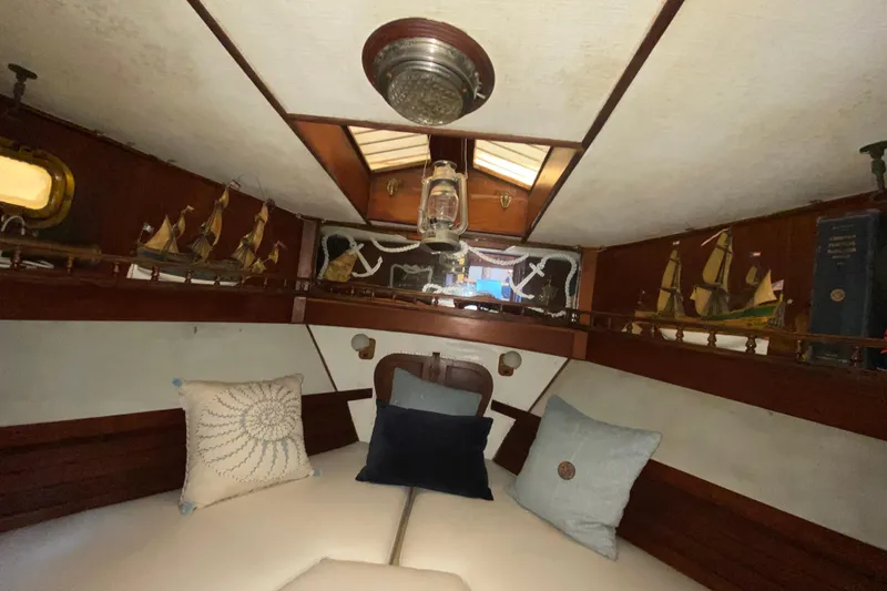 Slide: The Image of Cozy 1974 CHB 34 boat interior with nautical decor and model ships. - 33