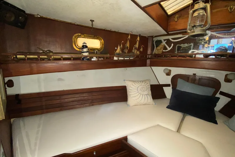 Slide: The Image of Cozy 1974 CHB 34 boat cabin with nautical decor and comfortable seating. - 35