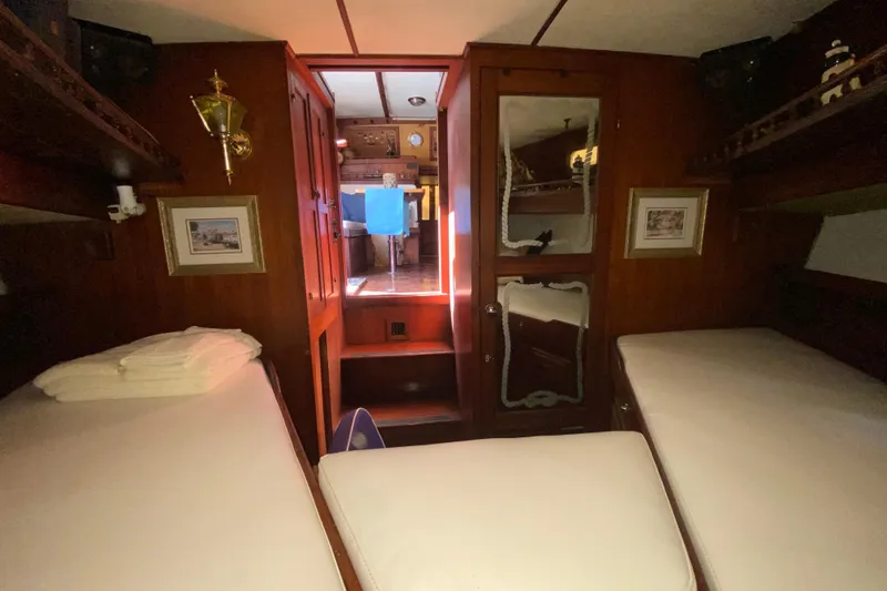 Slide: The Image of Interior of a 1974 CHB 34 boat cabin with wooden decor and twin beds. - 36