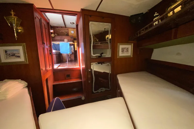 Slide: The Image of Interior of a 1974 CHB 34 boat, featuring cozy wooden cabin and bunks. - 37