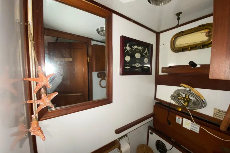 Slide: The Image of 1974 CHB 34 boat interior with nautical decor, mirror, and starfish ornaments. - 39