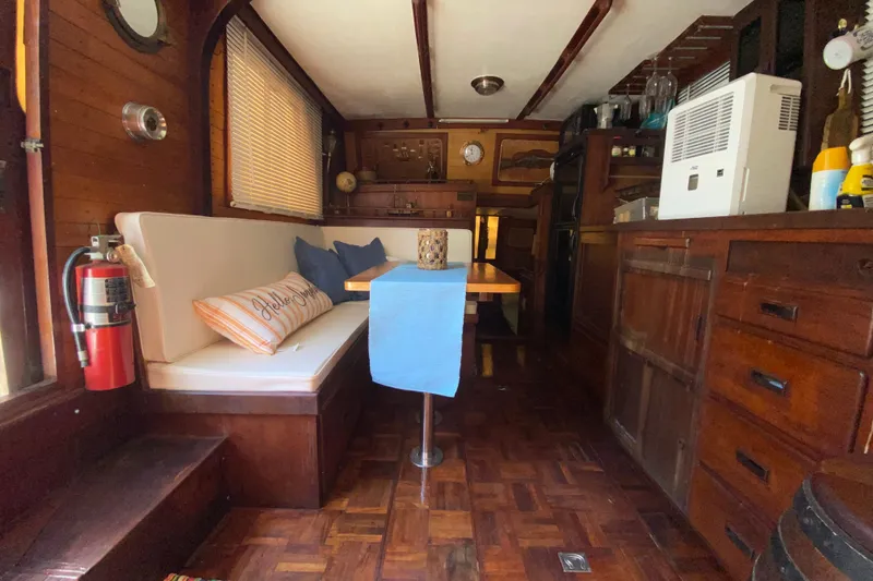 Slide: The Image of Interior of a 1974 CHB 34 boat with wooden decor and cozy seating area. - 40