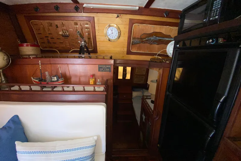 Slide: The Image of Cozy 1974 CHB 34 boat interior with nautical decor and wooden furnishings. - 42