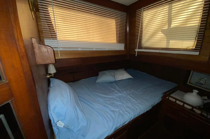 Slide: The Image of Cozy cabin bedroom in 1974 CHB 34 boat with wooden interior and blue bedding. - 45