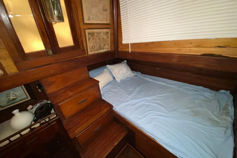 Slide: The Image of Cozy wooden cabin interior with bed, stairs, and nautical decor on a 1974 CHB 34 boat. - 46